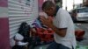 Marvin Sanabria, a Central American migrant traveling with a caravan to the U.S., kneels in prayer after waking up, in Huixtla, Mexico, Oct. 23, 2018. 