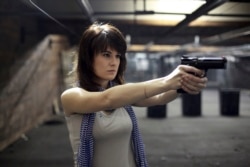 FILE - Maria Butina poses for a photo at a shooting range in Moscow, Russia, April 22, 2012.