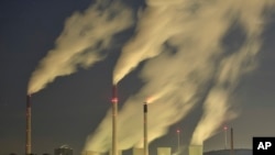 FILE - Smoke streams from the chimneys of the E.ON coal-fired power station in Gelsenkirchen, Germany, Nov. 24, 2014.