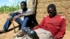 FILE - Zimbabweans listen to a radio for an announcement of election results in Umguza, Apr. 1, 2008. 