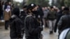 FILE - Members of Kurdish security forces known as Asayish stand guard in the northeastern Syrian city of Qamishli, Jan. 20, 2021.
