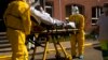 A coronavirus patient is transferred from a hospital to a home for the elderly by members of the medical staff of Klinicare in Brussels, April 1, 2020.