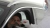 FILE - A health worker collects a sample at a drive-through COVID-19 screening center at the Ain Shams field hospital, in Cairo, Egypt, June 15, 2020.