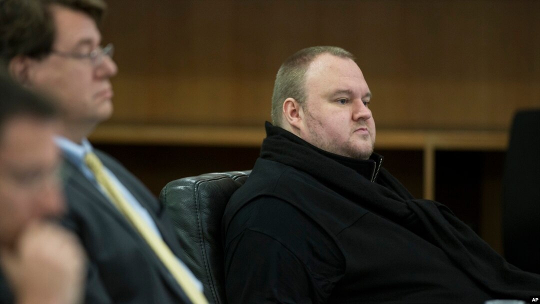 FILE - Kim Dotcom sits in the Auckland District Court during an extradition hearing in Auckland, New Zealand.