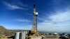 FILE - Crews work on stopping a gas leak at a relief well at the Aliso Canyon facility above the Porter Ranch area of Los Angeles, Dec. 9, 2015. The gas-storage facility had spewed methane for almost four months, driving thousands of families from their homes.