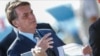 Brazil's President Jair Bolsonaro holds a paper with a print of the WhatsApp message with former minister Sergio Moro, written below in Portuguese: "This is gossip" as he leaves Alvorada Palace, in Brasilia, Brazil May 4, 2020.