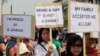 FILE - Indonesian gay activists hold posters during a protest demanding equality for lesbian, gay, bisexual and transgender people in Jakarta, May 21, 2011.