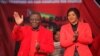 Zimbabwean Prime Minister and Movement for Democractic Change (MDC) President Morgan Tsvangirai, left, and his wife Elizabeth greet the audience on the first day of the party's National Policy Conference in Harare, May 17, 2013.