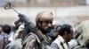 A tribesman loyal to the Houthi movement carries his rifle as he attends a gathering in Yemen's capital Sanaa, April 17, 2016.