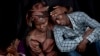 Bizimana Emmanuel, who was born two years before the genocide, is consoled by an unidentified woman while attending a ceremony to mark the tragedy's 20th anniversary, Kigali, April 7, 2014.