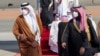 In this photo provided by the Saudi Royal Court, Saudi Arabia's Crown Prince Mohammed bin Salman, right, welcomes Qatar's Emir Sheikh Tamim bin Hamad al-Thani upon his arrival to attend the Gulf Cooperation Council's 41st Summit in Al-Ula, Jan. 5, 2021.