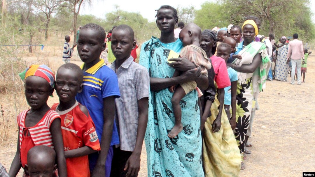 FILE - Residents displaced due to the recent fighting between government and rebel forces in the Upper Nile capital Malakal wait at a World Food Program (WFP) outpost where thousands have taken shelter in Kuernyang Payam, South Sudan, May 2, 2015. 
