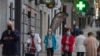People wearing face masks to protect against coronavirus walk during their allocated time slots for age groups and activities in Madrid, Spain, May 13, 2020.