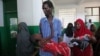 Internally displaced man carries cholera-stricken son through paediatric ward, Banadir hospital, Mogadishu, Aug. 25, 2011.