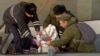 In this Tuesday, Dec. 27, 2016 frame grab made available by Russian Rossiya One TV Channel Emergency Ministry soldiers pack a flight recorder of the crashed plane, on a pier just outside Sochi, Russia.