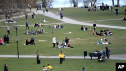 FILE-People visit the Raslambshovsparken Park in Stockholm, Sweden, Saturday April 18, 2020.