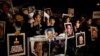 Israelis hold placards depicting people who were killed in pro-Palestinian attacks during a protest against the release of Palestinian prisoners, outside Israel&#39;s Prime Minister Benjamin Netanyahu&#39;s residence in Jerusalem, Mar. 26, 2014.