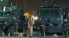 Riot policemen stand guard outside the French embassy in Sanaa, Yemen, September 19, 2012.