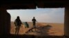 FILE - Iraqi Shi'ite fighters secure the border area with Syria in Al Qaim in Iraq's Anbar province, Nov. 12, 2018.