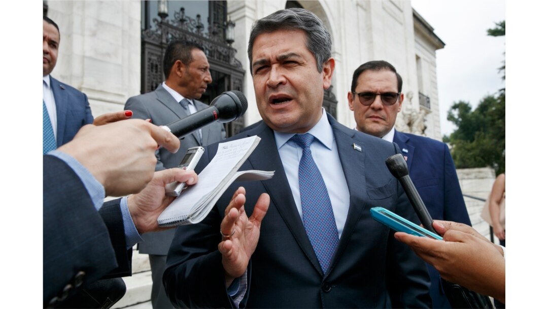 FILE - Honduran President Juan Orlando Hernandez answers questions from the Associated Press, August 13, 2019, as he leaves a meeting of the Organization of American States, in Washington.