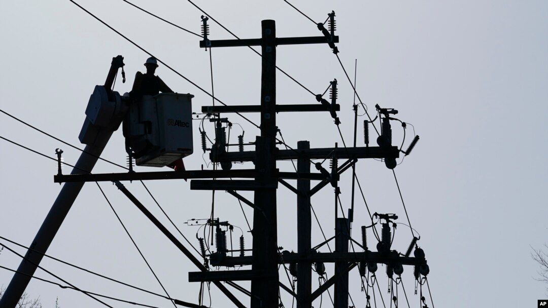 FILE - A worker works on the power lines in Annapolis, Maryland., on Dec. 15, 2021. 