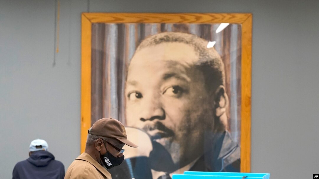 Chicago residents participate Oct. 15, 2020, in early voting at the Dr. Martin Luther King, Jr. Center in Chicago. 