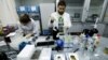 FILE - Technicians Ilya Podolsky and Natalia Bochkaryova work at the Russian anti-doping laboratory in Moscow, Russia, May 24, 2016.
