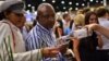 A couple at the WineX Wine Festival in Sandton samples the red wine from Leopard's Leap, a winery on the Western Cape of South Africa, October 2012. (VOA/Peter Cox) 