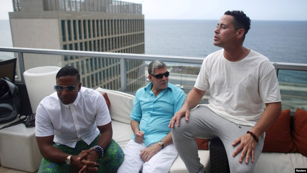(L-R) Members of the Cuban fusion group Orishas, Yotuel, Roldan and Ruzzo, give an interview from the top of a building in Havana, Cuba, June 22, 2016. 