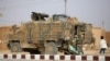 FILE - A Turkish soldier stands near his armored vehicle on a highway near the northern Syrian town of Ain Issa in the countryside of the Raqqa region, Nov. 26, 2019, as Turkey-backed forces were deploying reinforcements around town.