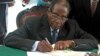 Zimbabwe President Robert Mugabe signs Zimbabwe's new constitution into law in Harare, May 22, 2013.