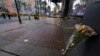 A bouquet of flowers leans at the intersection of Bourbon and Canal streets during the investigation of a pickup truck that rammed into a crowd of revelers early on New Year's Day in New Orleans, Louisiana, Jan. 1, 2025.