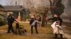 Police officers evacuate an elderly resident from her home during the Eaton Fire in Altadena, California, on Jan. 8, 2025.
