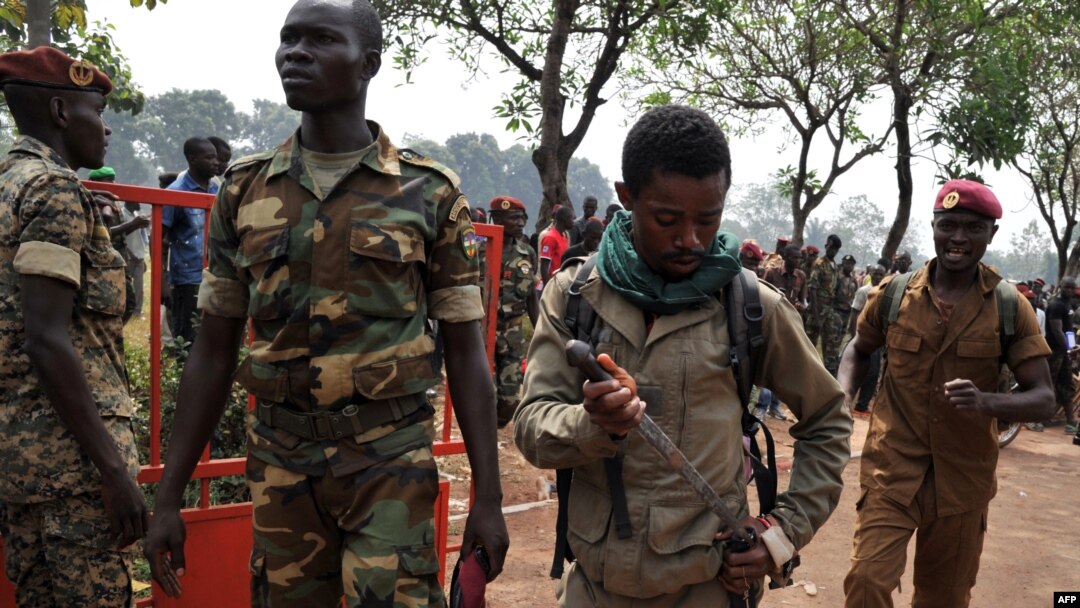 A member of the Central African Armed Forces (FACA) puts his knife away after taking part in the lynching of a man suspected of being a former Seleka rebel on Feb. 5, 2014, in Bangui. 