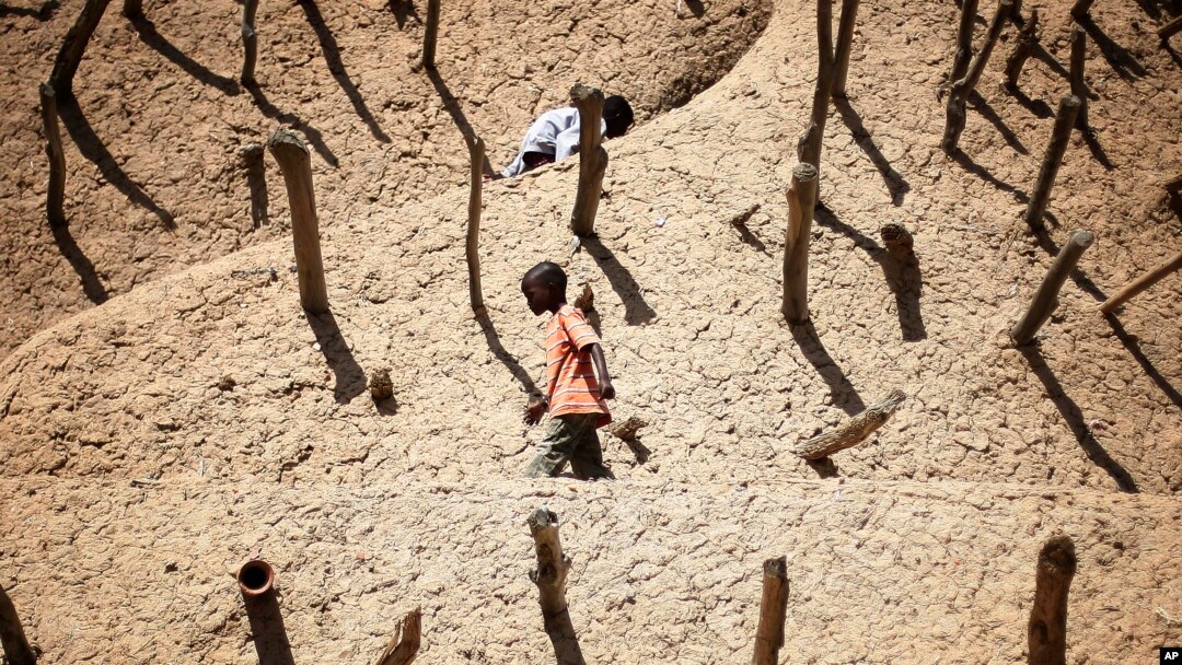 Children walk on the Askia mausoleum, built in 1495 in Gao, northern Mali, February 15, 2013, one week after a suicide bomber on a motorcycle killed himself attempting to blow up an army checkpoint at the entrance of the town. 