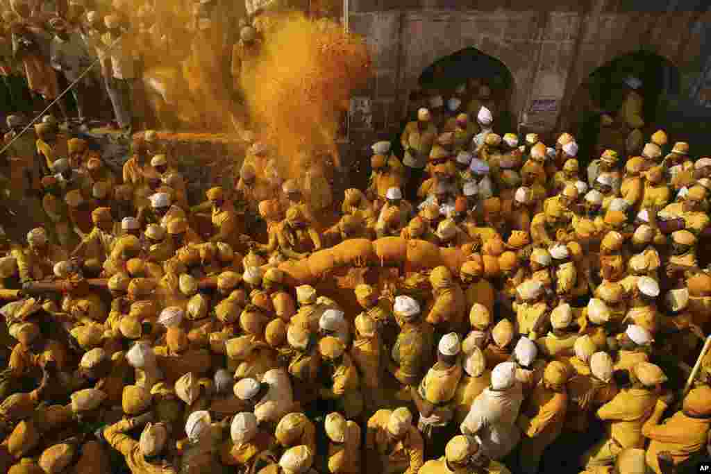 Devotees carry a palanquin during a procession at the temple of the shepherd god Khandoba on 'Somavati Amavasya' at the Jejuri temple in Pune district, Maharashtra state, India.