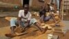 FILE - Artisanal miners crush tin ore before it is washed and then bagged ready for sale in Nyabibwe, a mining town in South Kivu, DRC.