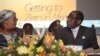 Zimbabwean Deputy Prime Minister Khupe, left, chats with President Mugabe at a women's empowerment event, Harare, May 24,2012.