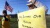 Jane Malin holds a sign as she waves to passing cars during a rally to show support for Muslim members of the community near the Clear Lake Islamic Center in Webster, Texas, Dec. 4, 2015. 