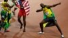 Jamaica's Usain Bolt celebrates after winning gold in the men's 100 meter final. Yohan Blake, left, and Justin Gatlin stand nearby, who won silver and bronze, respectively.