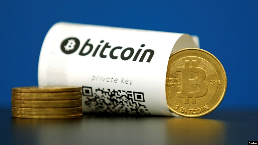 A Bitcoin (virtual currency) paper wallet with QR codes and a coin are seen in an illustration picture taken at La Maison du Bitcoin in Paris, France, May 27, 2015. REUTERS/Benoit Tessier/File Photo - RTX2CE24