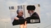 A man holds a picture of Iran's supreme leader Ayatollah Ali Khamenei with Iranian Revolutionary Guards top commander Qasem Soleimani during a demonstration in Tehran, Jan. 3, 2020, against the killing of Soleimani in a U.S. strike in Baghdad.