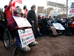FILE - Protesters, some in wheelchairs, rally against what they see as failures in Russia's health care system, in Moscow, Nov. 2, 2014.