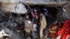 FILE - People search for survivors under the rubble of a house destroyed by Saudi-led airstrikes that killed a TV director, his wife, and three children in Sanaa, Yemen, Feb. 10, 2016.