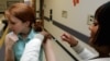FILE - A woman gets a flu shot on the Emory University campus in Atlanta, Georgia. 