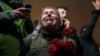 A woman cries as she and others gather in a moment of silence to mark the first anniversary of the country's catastrophic earthquake, in Antakya, Turkey, on Feb. 6, 2024.