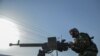 Afghan security personnel and Afghan militia fighting against Taliban stand guard in Enjil district of Herat province on July 30, 2021.