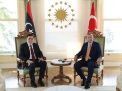 Turkey's President Recep Tayyip Erdogan, right, and Fayez Sarraj, the head of Libya's internationally-recognized government, pose together prior to their official talks in Istanbul, Sept. 6, 2020.