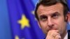 FILE - French President Emmanuel Macron looks on during a joint press conference with Germany's Chancellor Olaf Scholz (out of frame) during an European Union (EU) summit at the European Council Building at the EU headquarters in Brussels, Dec. 17, 2021