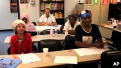 Syrian refugee Ahmad Alabood, rear, sits in the back row during English class at Della Lamb Community Services in Kansas City, Mo., on June 13, 2016. 